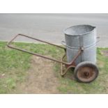 A vintage two wheeled water barrow, the iron frame supporting a cylindrical galvanised vessel