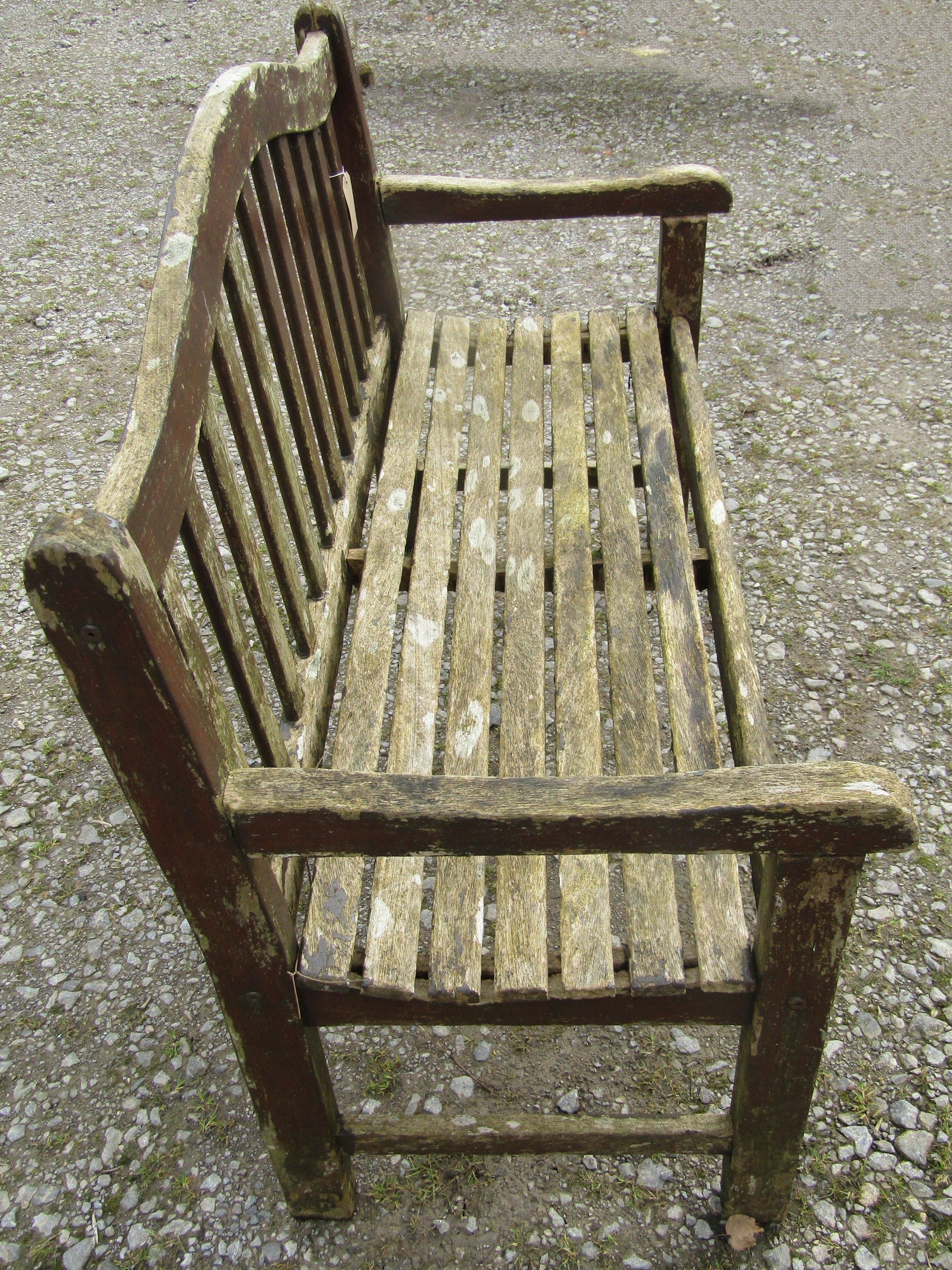 A weathered and stained teak garden bench with slatted seat and back beneath an arched rail, 120 cm, - Image 3 of 5