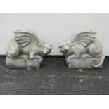 A pair of good quality cast composition stone pier ornaments in the form of Griffins set on