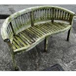 A Cotswold Collection weathered teak banana shaped garden bench (af) 160 cm