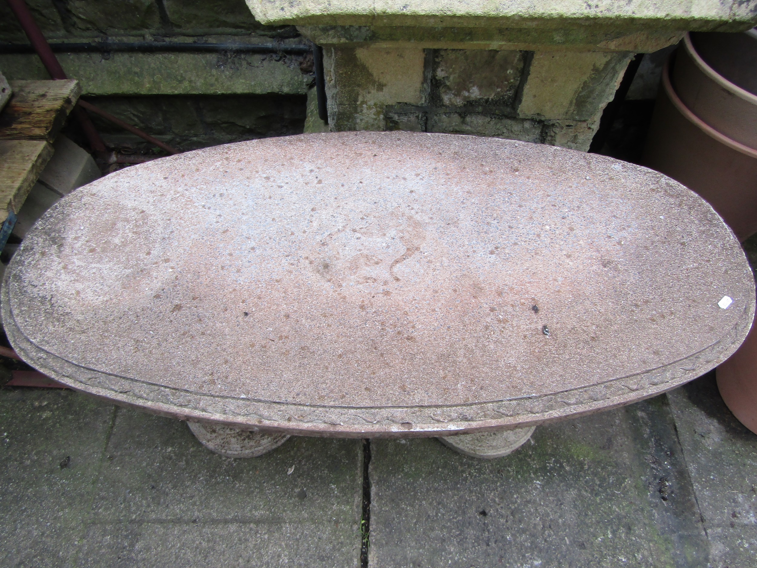 A novelty weathered three sectional composition stone garden table with oval top on standing otter - Image 4 of 4