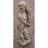 A weathered cast composition stone garden ornament in the form of a standing classical maiden