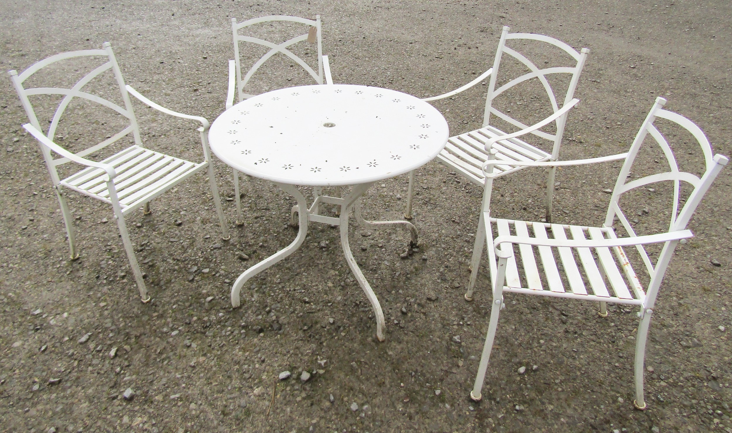 A cream painted cast alloy garden terrace table the circular top with pierced petal detail 90- cm