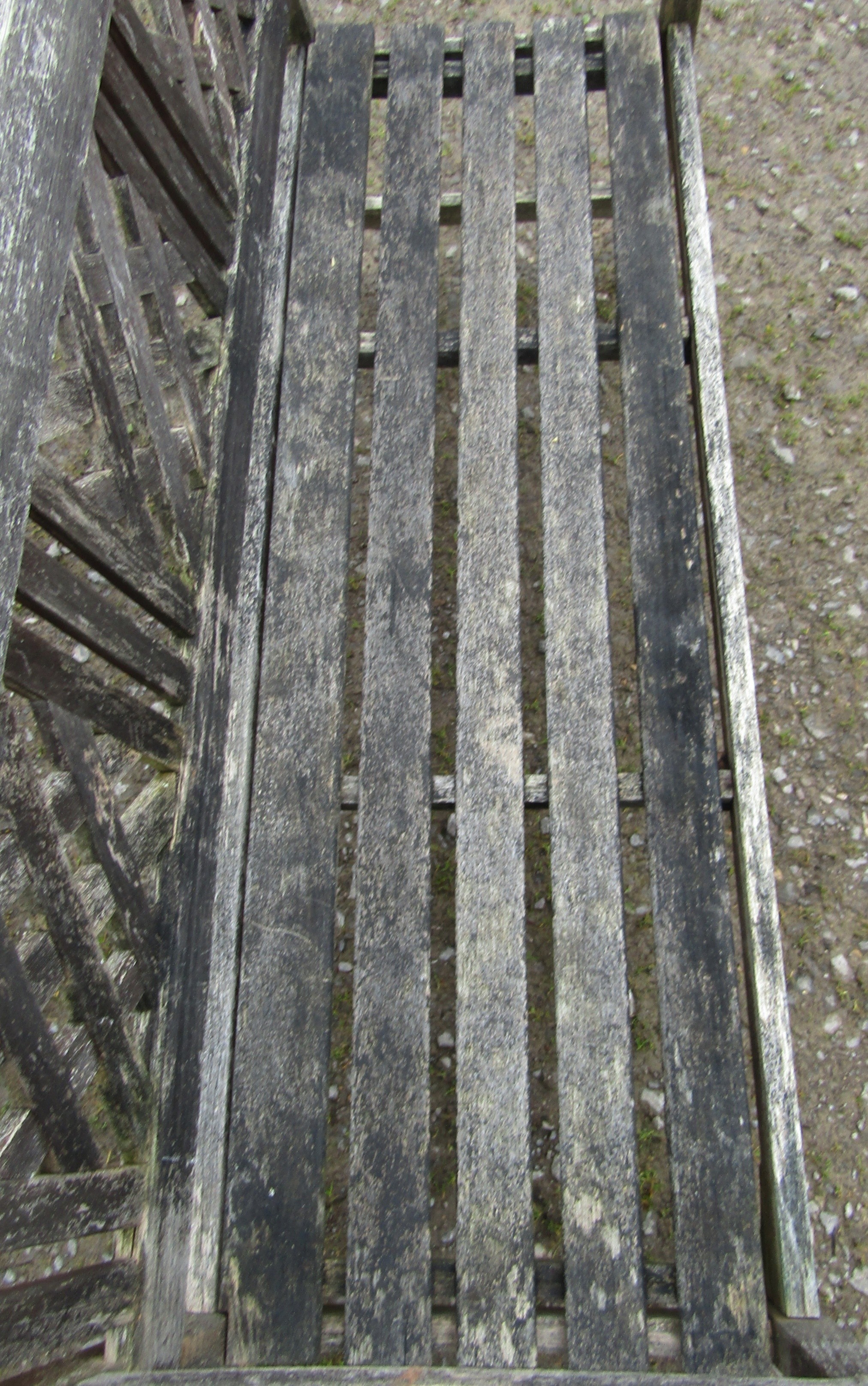 A weathered three seat garden bench with slatted seat and lattice panelled back beneath a shaped - Image 4 of 5