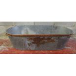 A vintage oval galvanised tin bath with iron fittings, 30 cm high x 119 cm x 55 cm