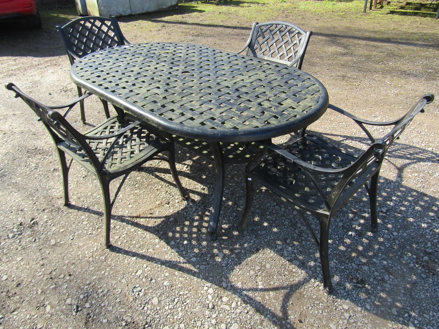A good quality contemporary heavy gauge cast alloy five piece garden terrace set comprising oval two