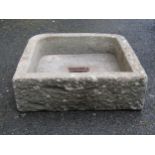 A weathered carved natural stone sink/trough with rounded front corners 17 cm high x 54 cm square