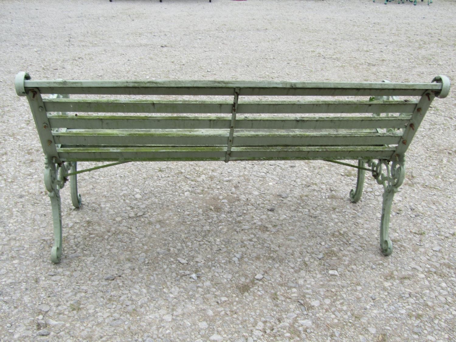 A light green painted garden bench with wooden slatted seat raised on decorative pierced and - Image 3 of 5