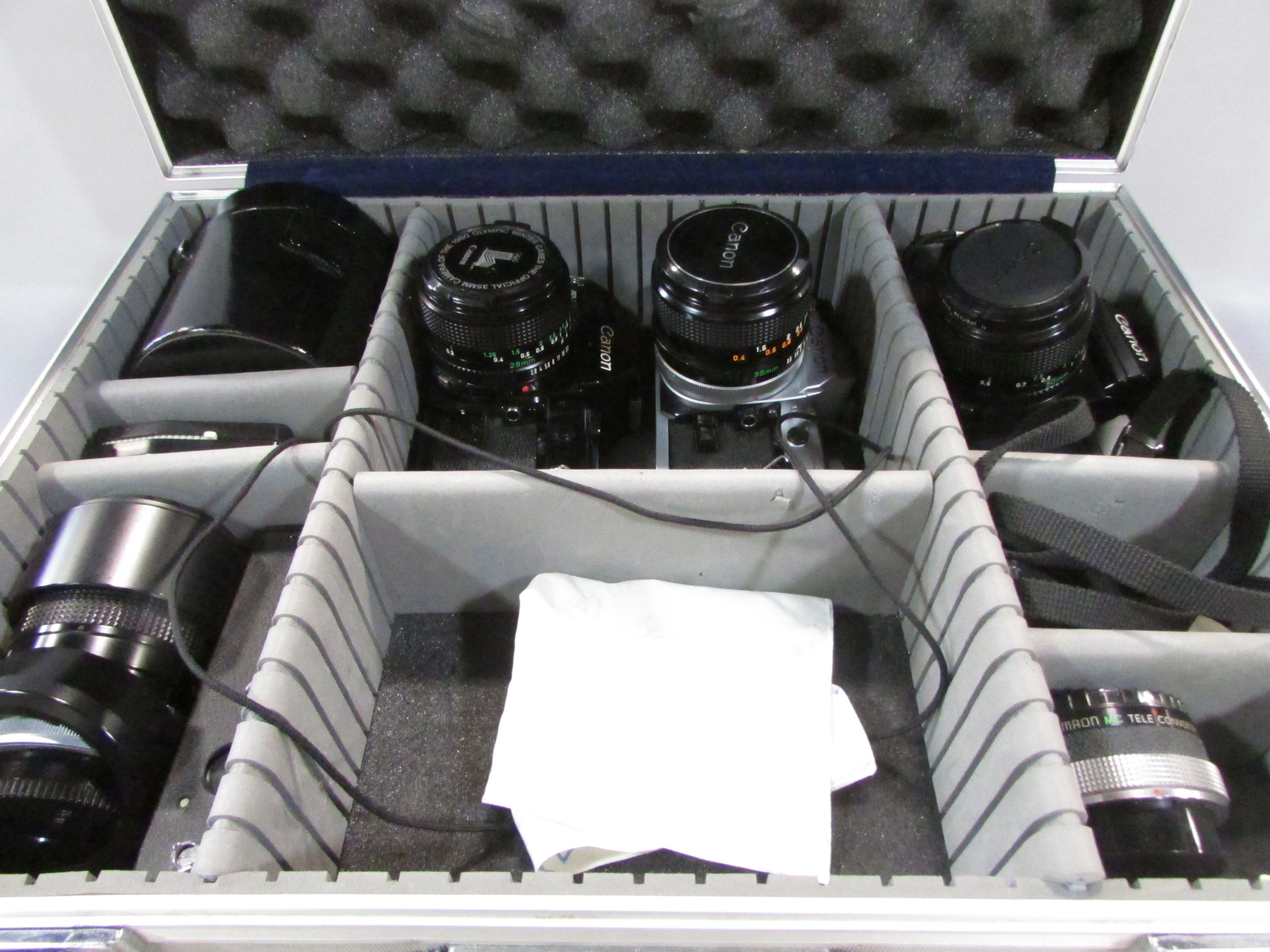 Three Canon cameras: models A1, AE1, F1, together with a 135 millimetre lens, 20 mm lens, all - Image 2 of 5