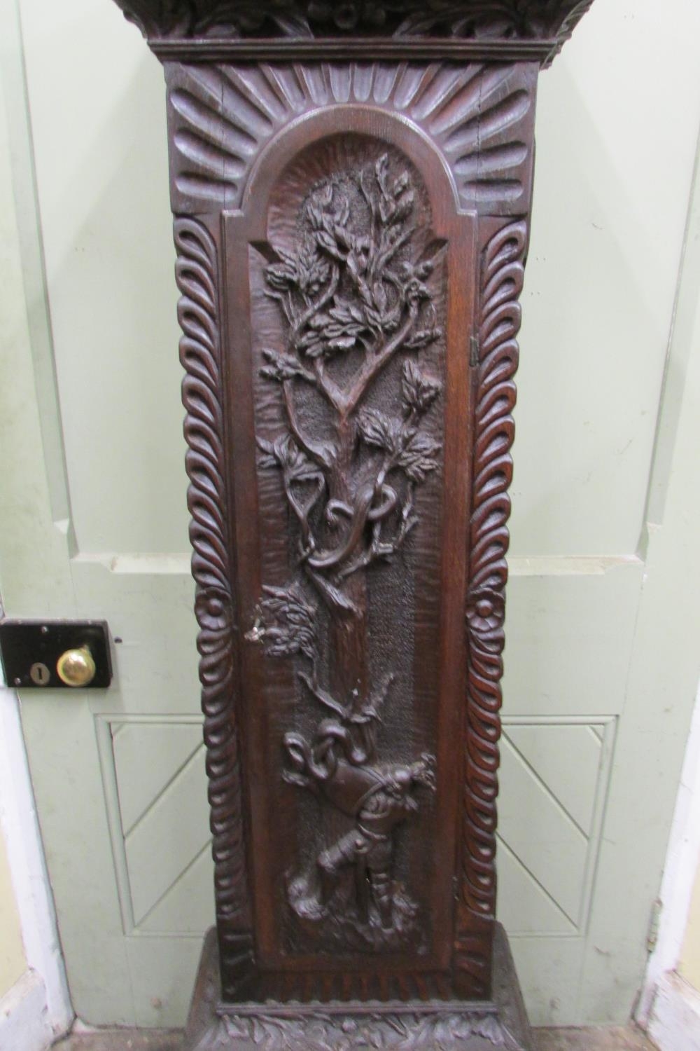 A 19th century oak longcase clock with heavy estate carving, the trunk detailing a knight fighting - Image 14 of 17