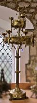 A large 19th century ecclesiastical brass floor-standing ten light chandelier, with pointed fleur-
