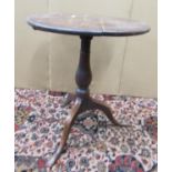 A Georgian cottage oak snap top table, the circular top 54cm diameter, raised on a turned pillar and
