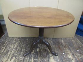 A Georgian mahogany snaptop table, the 83cm diameter top raised on a simple gun barrel pillar and