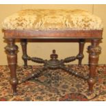 A Victorian rosewood centre stool raised on turned and tapering supports, united by four turned