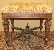 A Victorian rosewood centre stool raised on turned and tapering supports, united by four turned