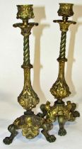 A pair of good quality 19th century cast metal candlesticks, decorated with grotesque and other