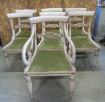 A set of seven Regency painted dining chairs with carved splats on fluted supports