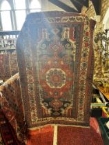 An old tribal Kazak Persian rug with an all over geometric pattern, worn in places, 204cm x 125cm