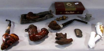 A collection of antique and vintage pipes, with carved wooden bowls , including a Ben Wade pipe, a