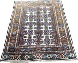North East Persian Turkoman rug, with a central panel of interlocking stepped geometric patterns,