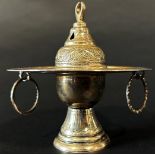 An Egyptian silver metal incense burner with ring handles below the dish and bowl and a pierced