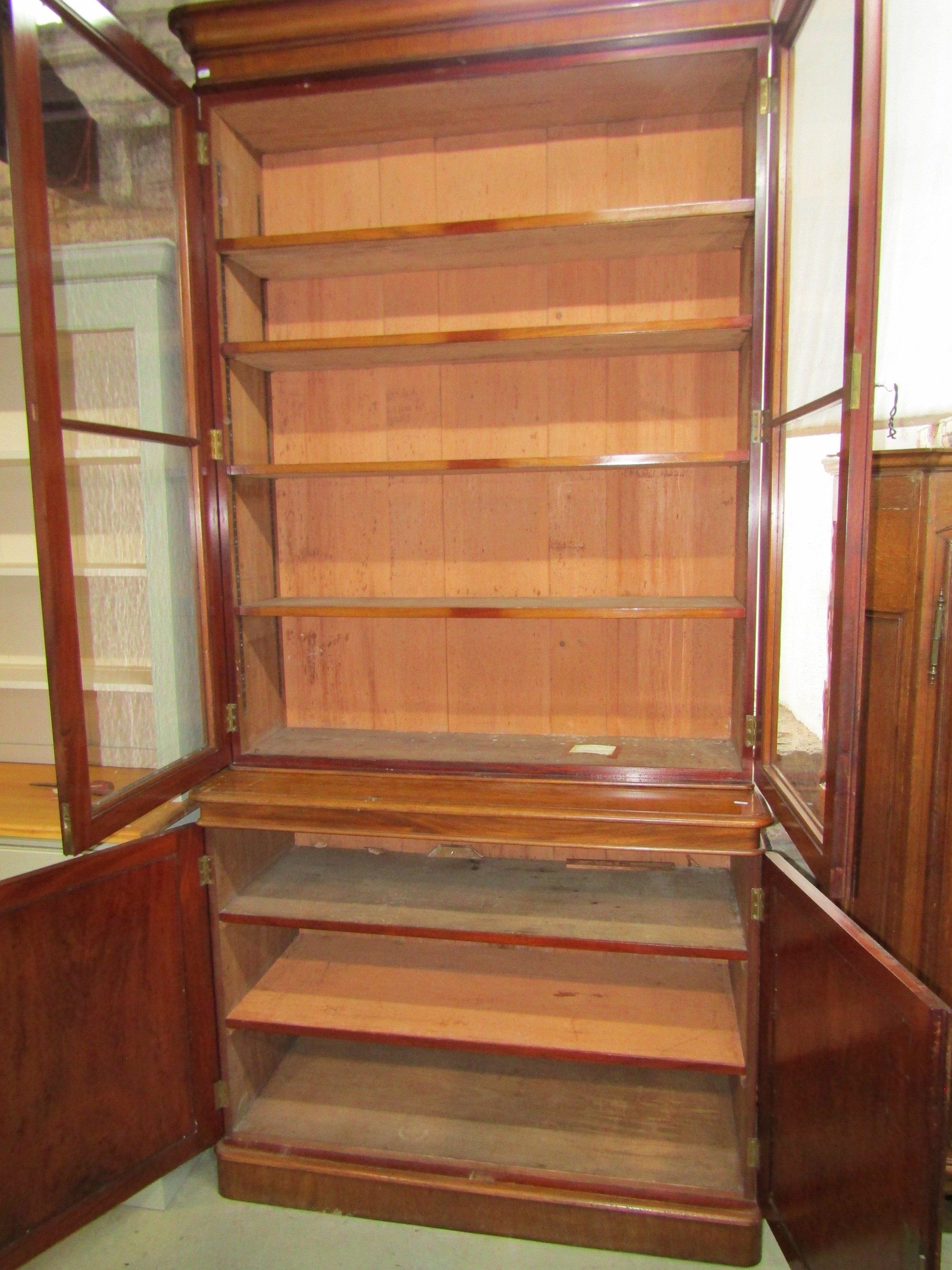 A Victorian mahogany library bookcase enclosed by a pair of arched panelled doors, the upper section - Image 2 of 3