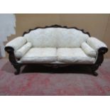 A Regency drawing room sofa with showwood frame depicting shells, scrolls and other detail, raised