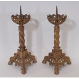 A pair of old English style ecclesiastical gilt brass pricket candlesticks, with pierced castellated