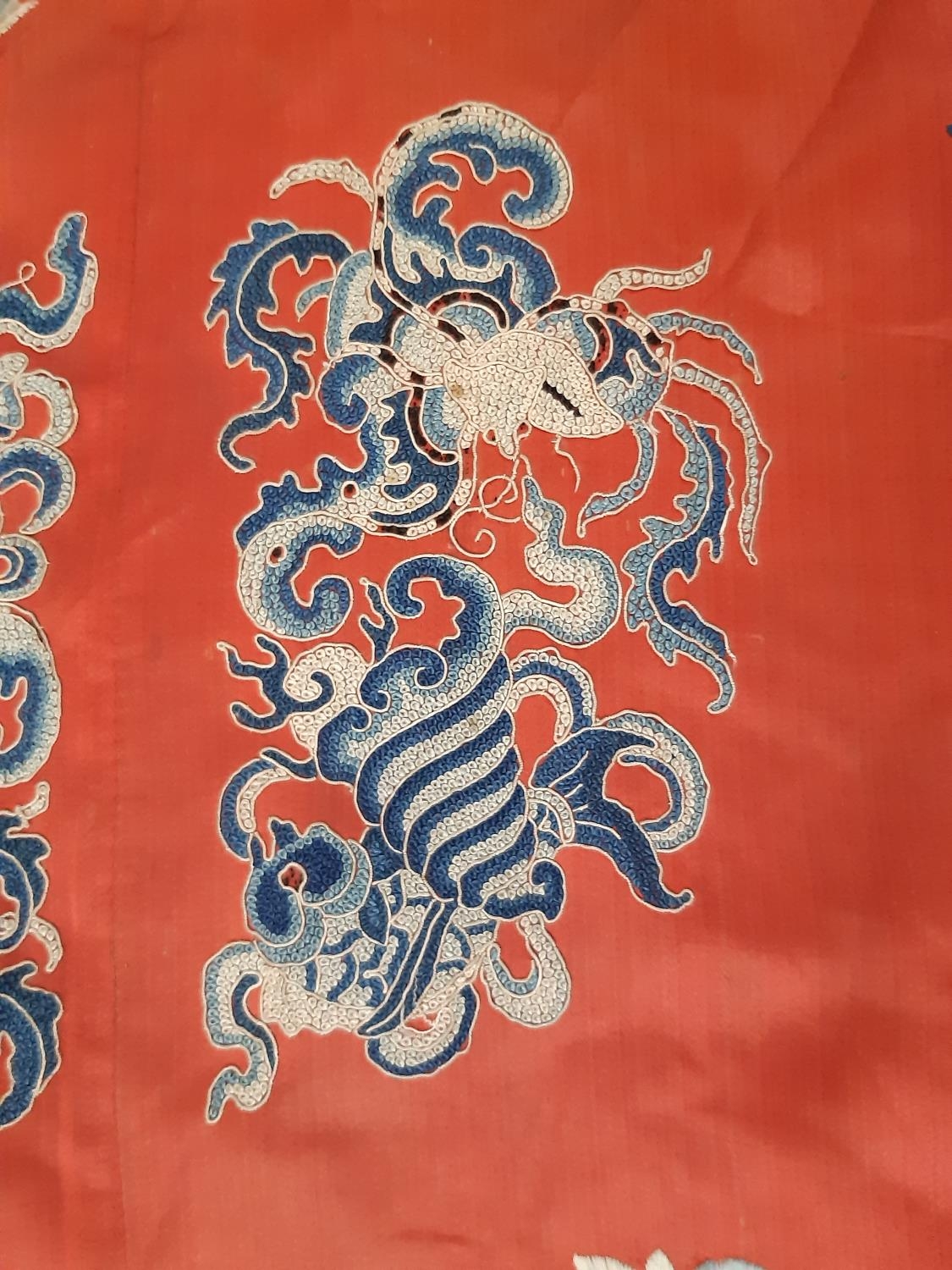 A late 19th/ early 20th century Chinese robe of red silk embroidered with flowers, moths and other - Image 4 of 8