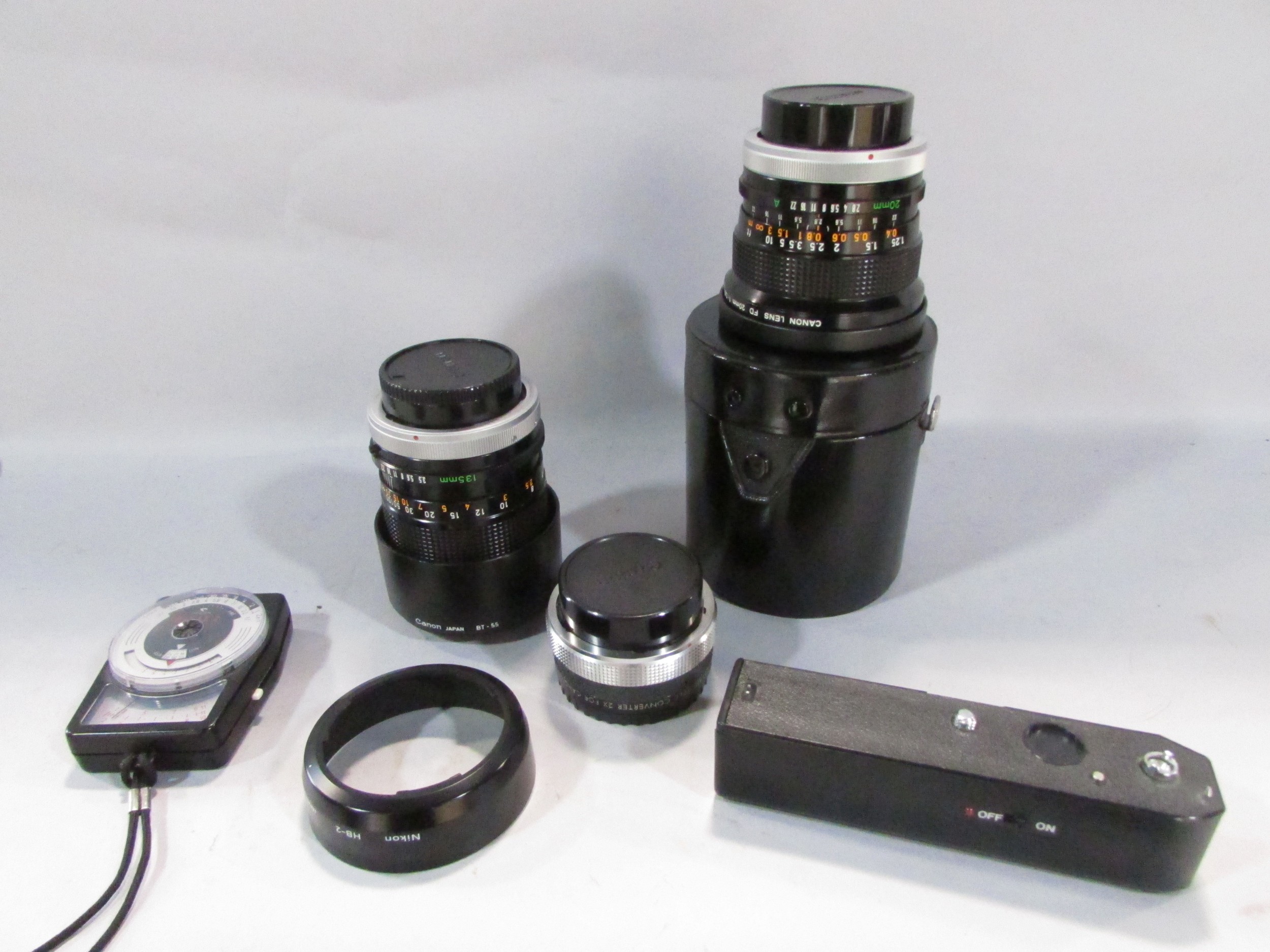Three Canon cameras: models A1, AE1, F1, together with a 135 millimetre lens, 20 mm lens, all - Image 5 of 5
