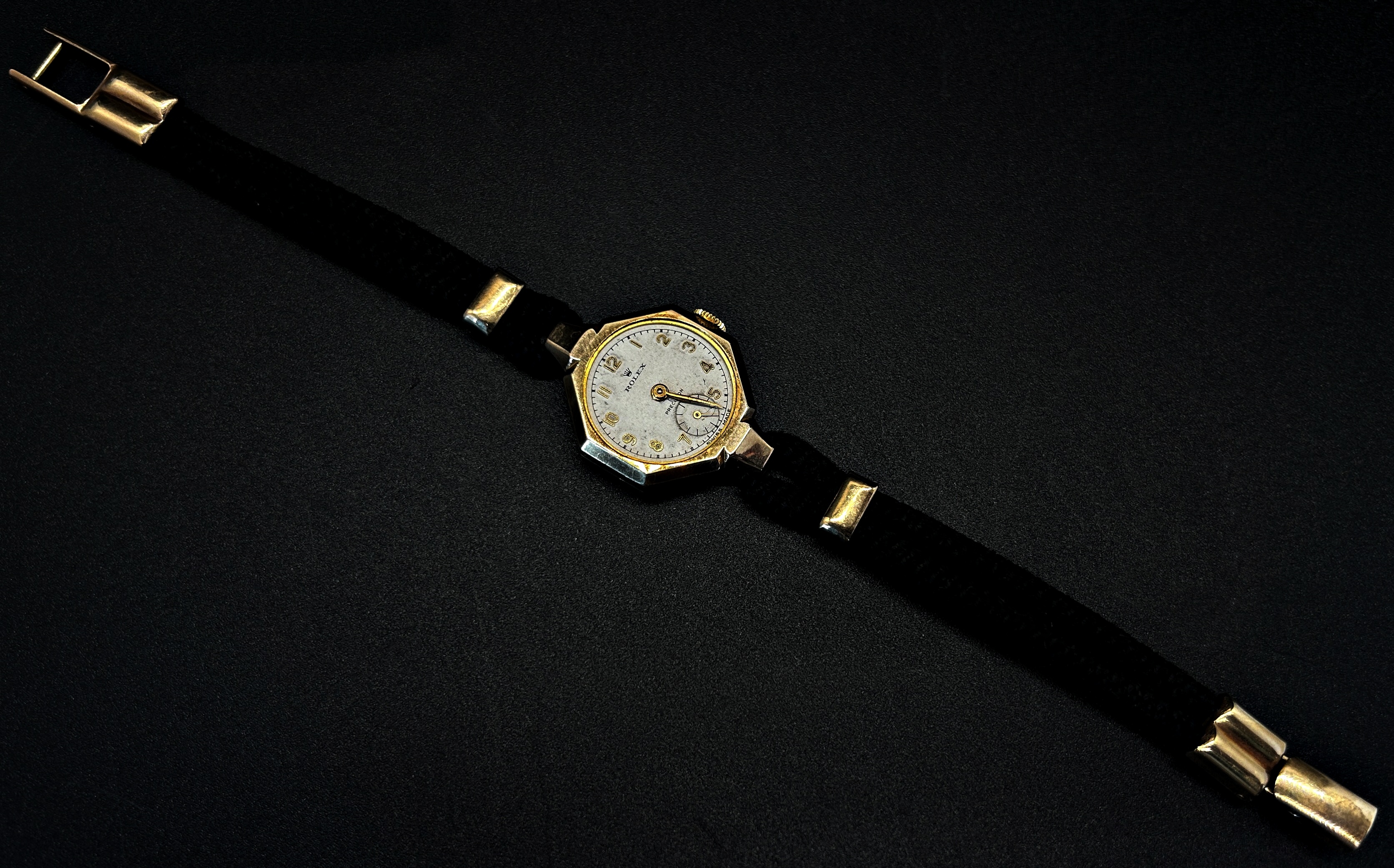 Rolex: A lady’s vintage wristwatch, with hexagonal case (lacking lens) on woven strap with 9ct