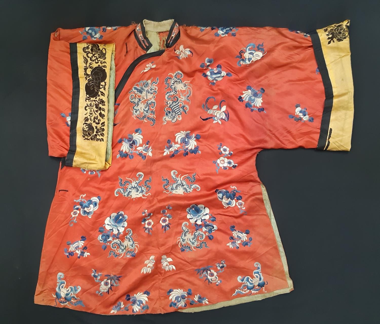 A late 19th/ early 20th century Chinese robe of red silk embroidered with flowers, moths and other - Image 3 of 8