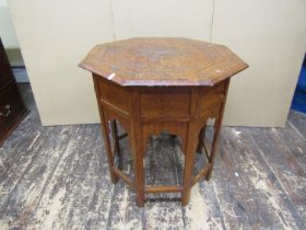 An Indian hardwood occasional table, the octagonal top with geometric brass inlay detail, raised