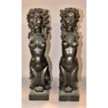 A pair of 19th century continental carved ebonised figures in the form of classical (Greek)