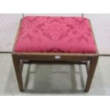 A Georgian mahogany upholstered stool on square tapered legs