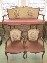 A Three piece salon suite with carved and moulded framework, the back panels with tapestry detail