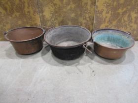 Three 19th century copper pans with iron handles, 45cm diameter and smaller