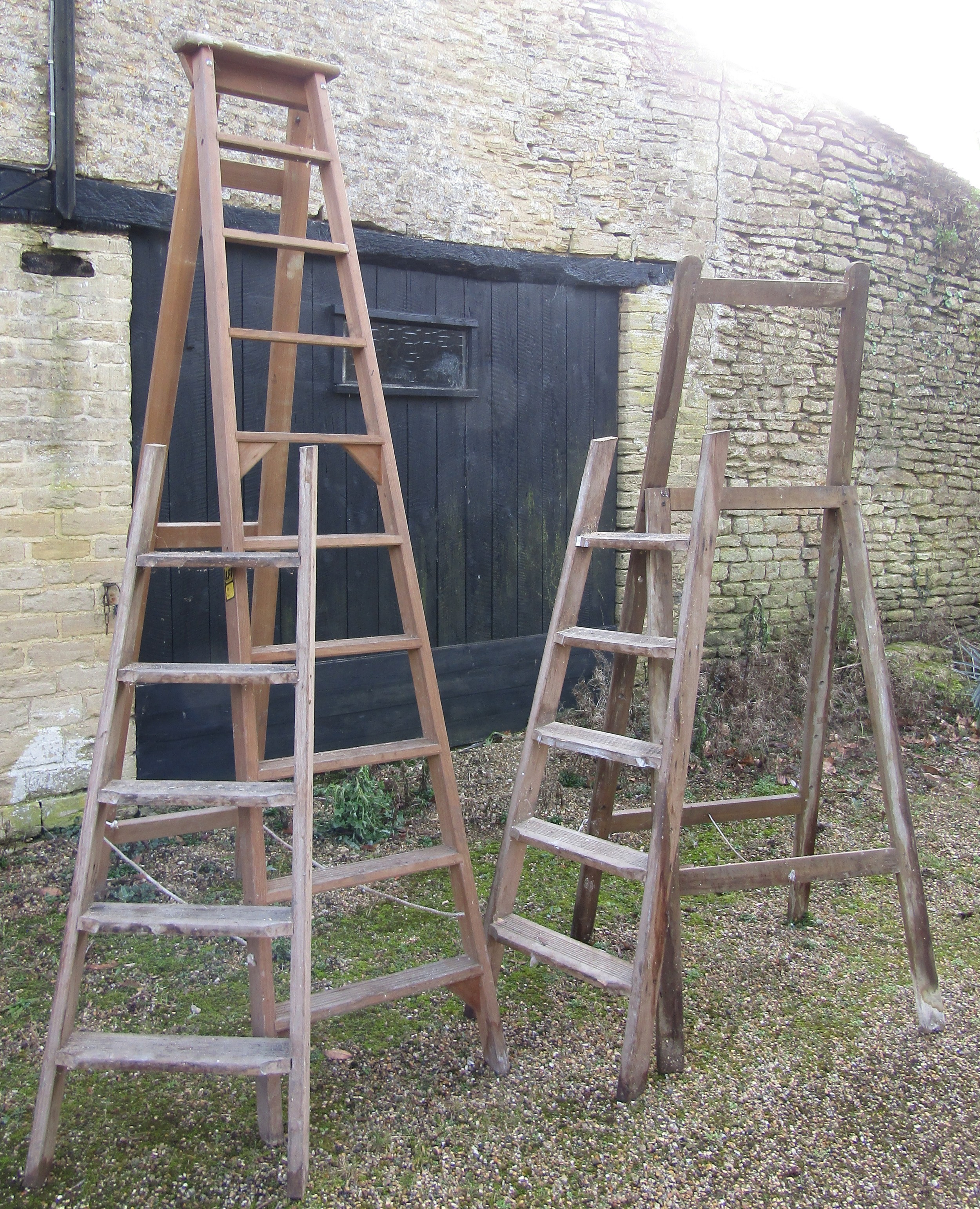 Two wooden folding steps ladders of varying size together with simple folding artists easel (3)