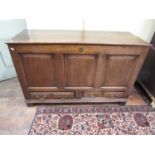 A Georgian oak mule chest with loose lid over a panelled frame and two long drawers, 86cm high,