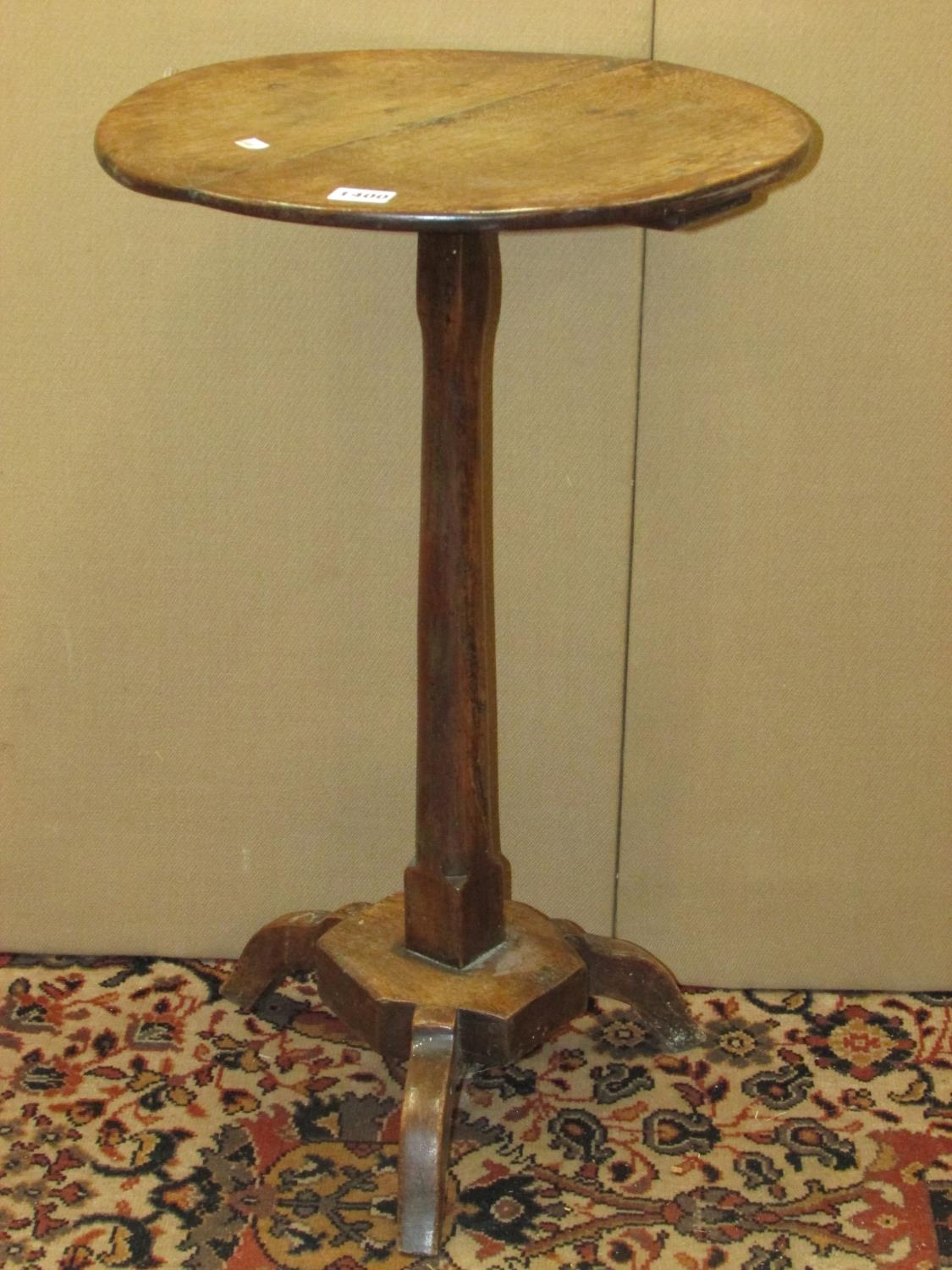 A simple Georgian countrymade occasional table in mixed woods, the oak top raised on a simple