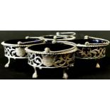 Four matching Victorian oval silver salt cauldrons with pierced filigree sides and loop handles,