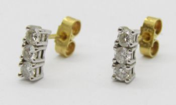 Pair of 18ct three stone diamond stud earrings, each stone 0.10ct approx, maker 'ATLd', London, 1.8g