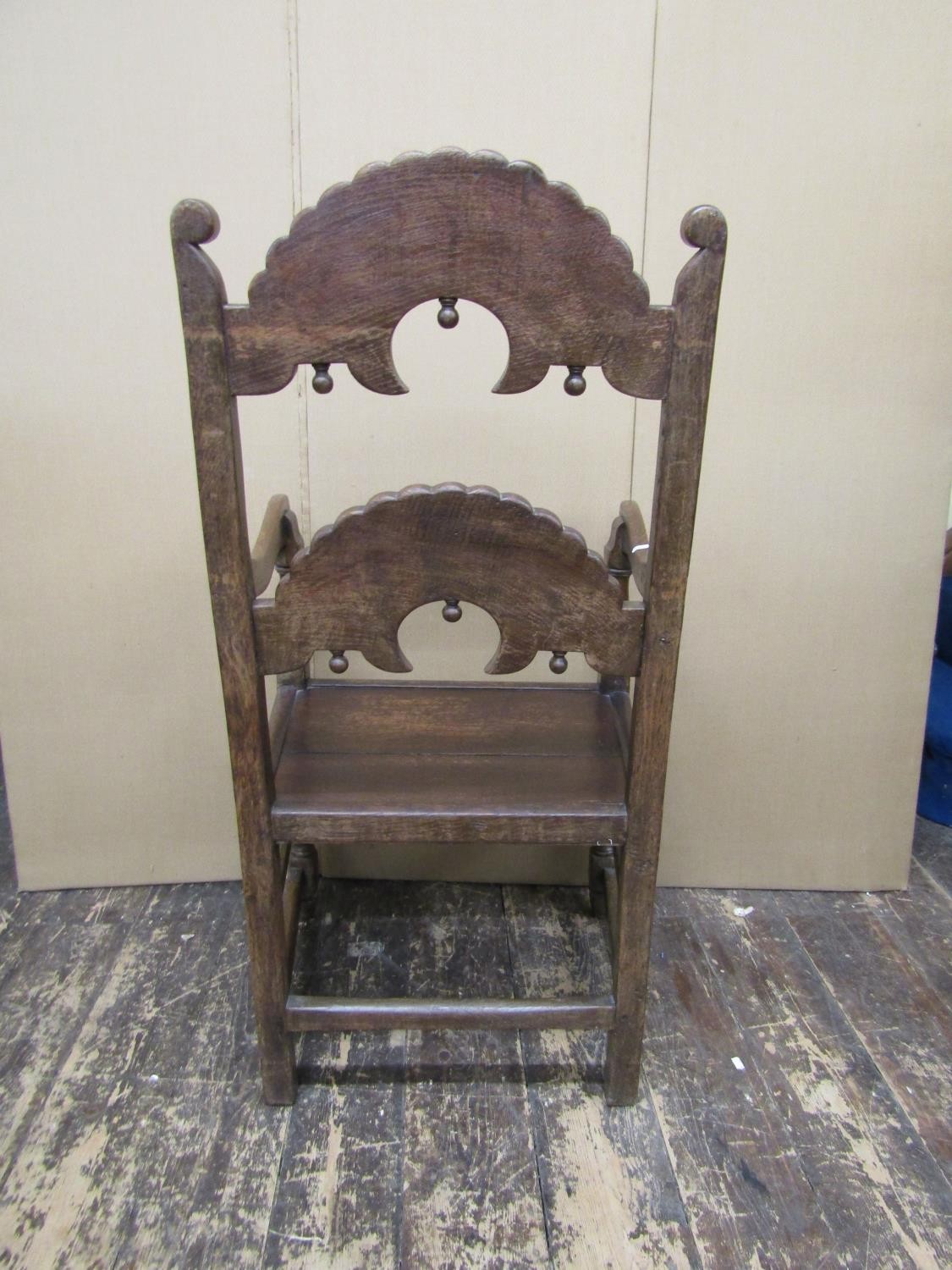 An antique oak South Yorkshire elbow chair of traditional form with carved and arched ladder back, - Image 4 of 4