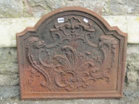 An old cast iron fire back with C scroll and other detail, 55cm high x 60cm wide