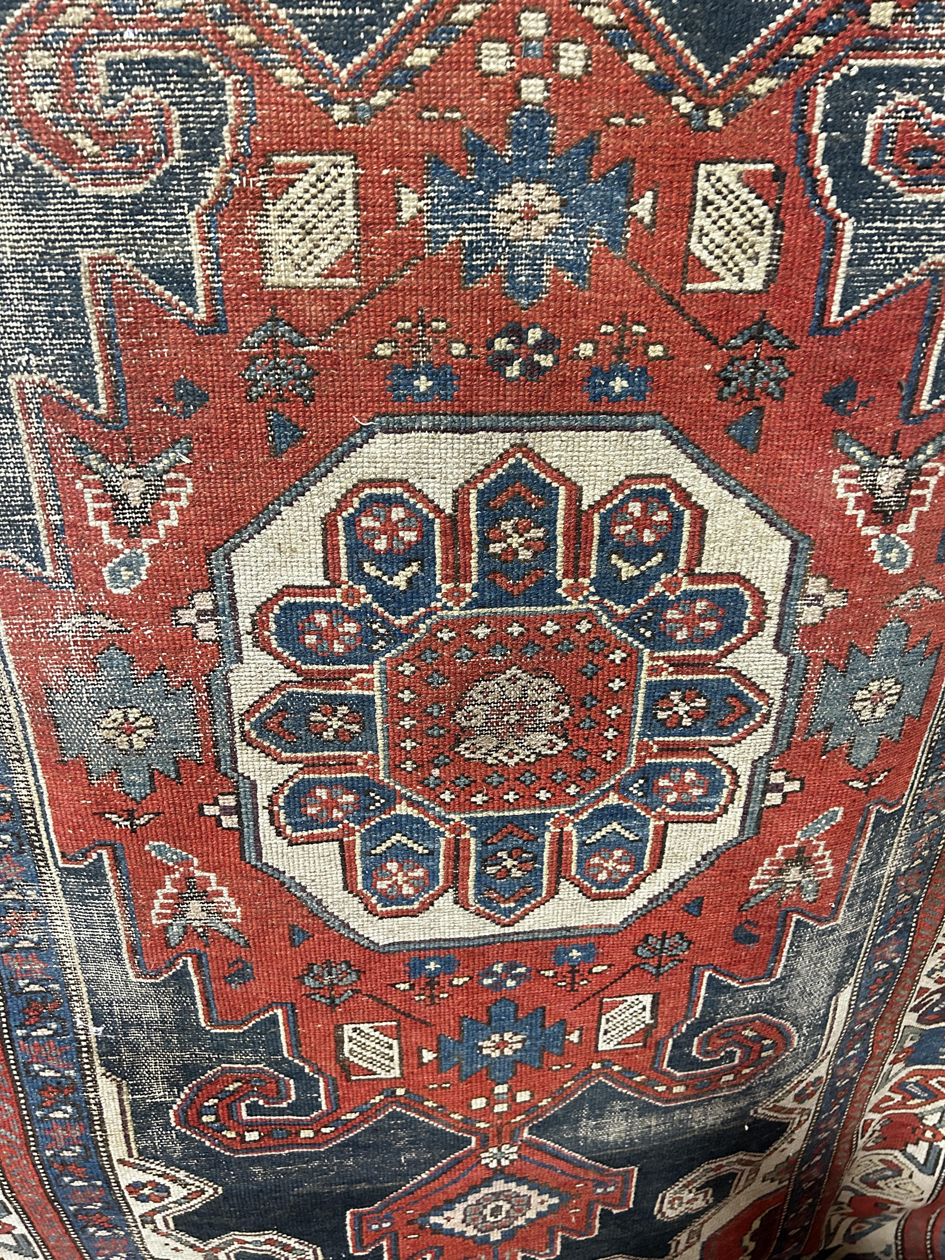 An old tribal Kazak Persian rug with an all over geometric pattern, worn in places, 204cm x 125cm - Image 3 of 3