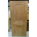 A 19th century stripped and waxed pine food/side cupboard enclosed by two panelled doors, with