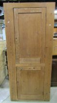 A 19th century stripped and waxed pine food/side cupboard enclosed by two panelled doors, with