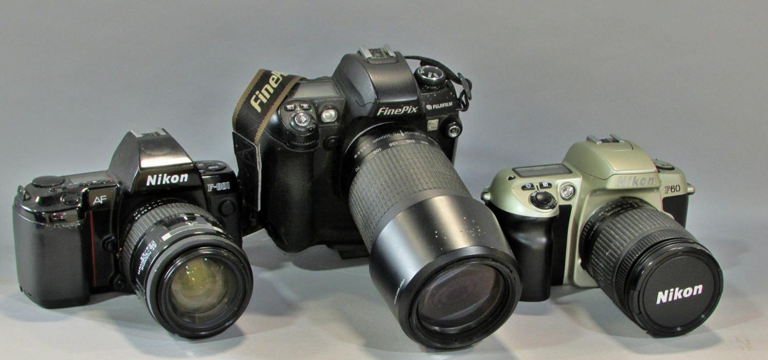 Three Nikon cameras models F60, F801, F4015 with a case together with a Fujifilm Finepix S3 PRO
