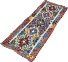 A Chobi kilim runner with five central stepped diamonds, 152 x 63cm approximately