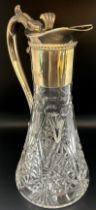 A late 20th century cut glass Georgian style claret jug with a silver collar spout and handle,